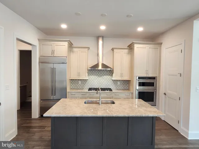 a view of kitchen with refrigerator microwave and wooden floor
