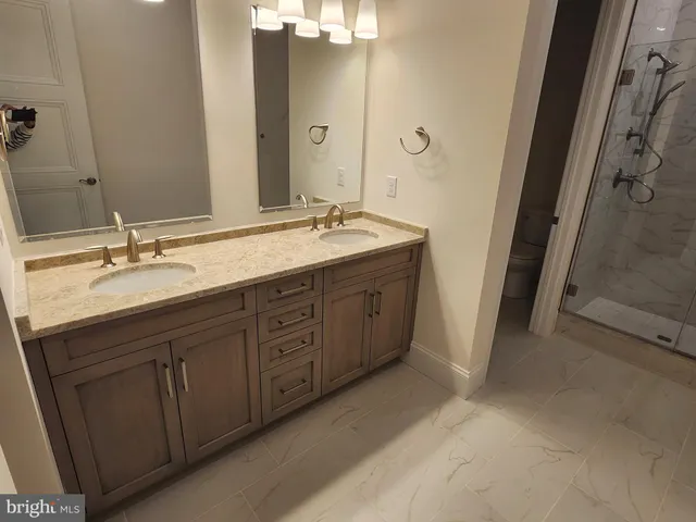 a bathroom with a double vanity sink and mirror
