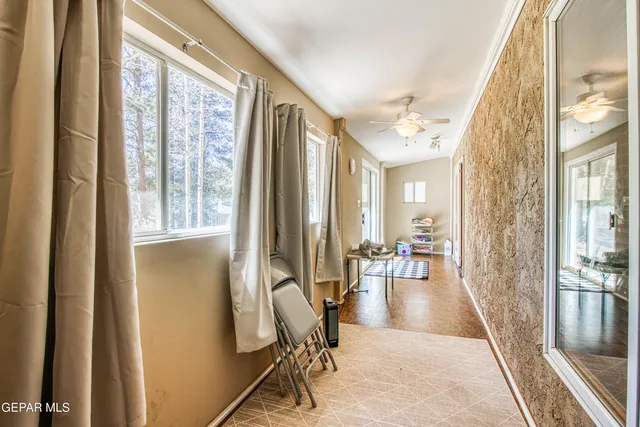 a living room with furniture and large windows