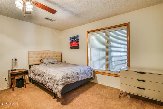 a bedroom with a bed and a dresser