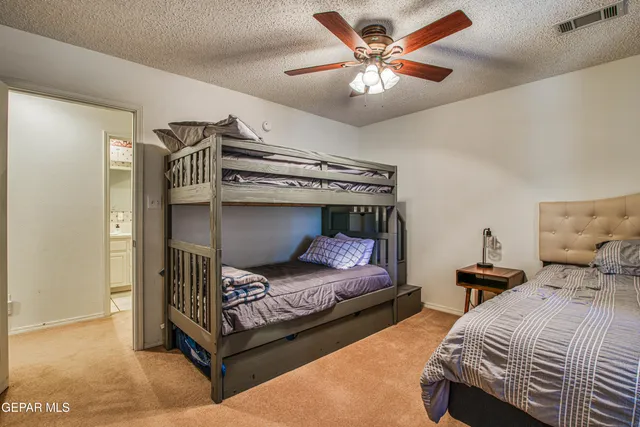 a bedroom with bed and a chandelier