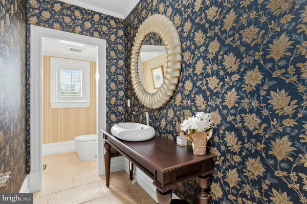 a bathroom with a sink mirror and toilet