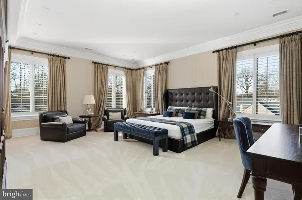 a spacious bedroom with a bed and a couch