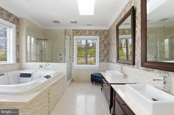 a spacious bathroom with sink shower and bathtub