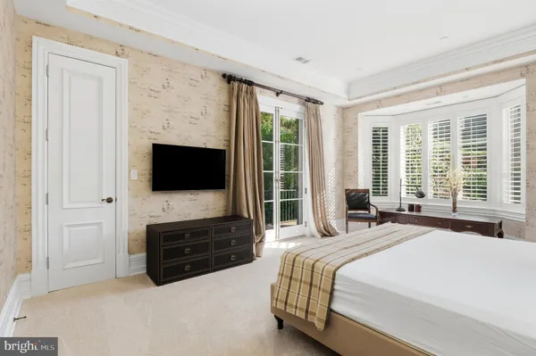 a bedroom with a flat screen television and a bed