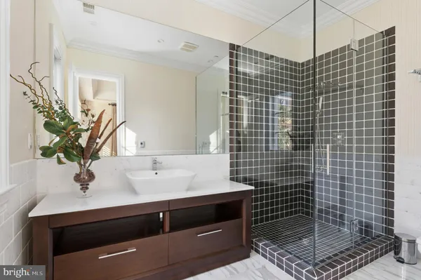 a bathroom with a sink a mirror and shower