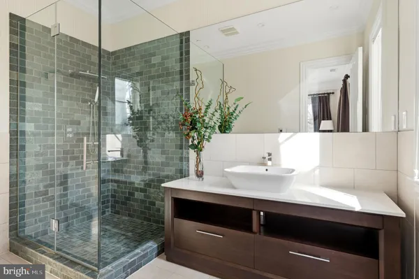 a bathroom with a shower sink and mirror