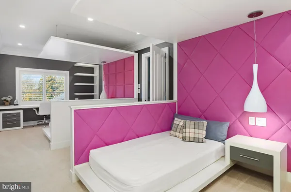 a bedroom with a bed a couch and dresser
