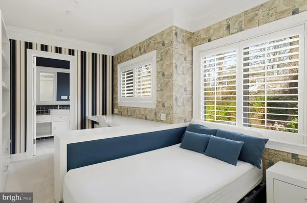 a bedroom with a large bed and a window