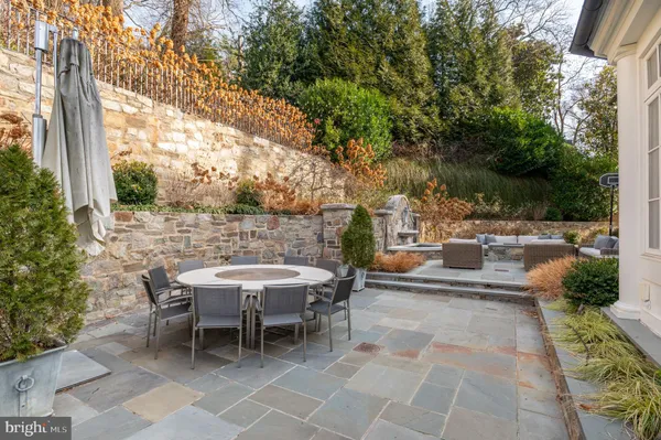 a view of a patio with table and chairs and potted plants