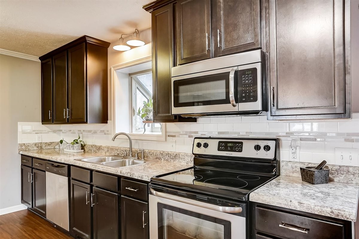 2087 River Road Clarksville, TN 37040 - Photo 14 of 33 a kitchen with a sink stove and microwave