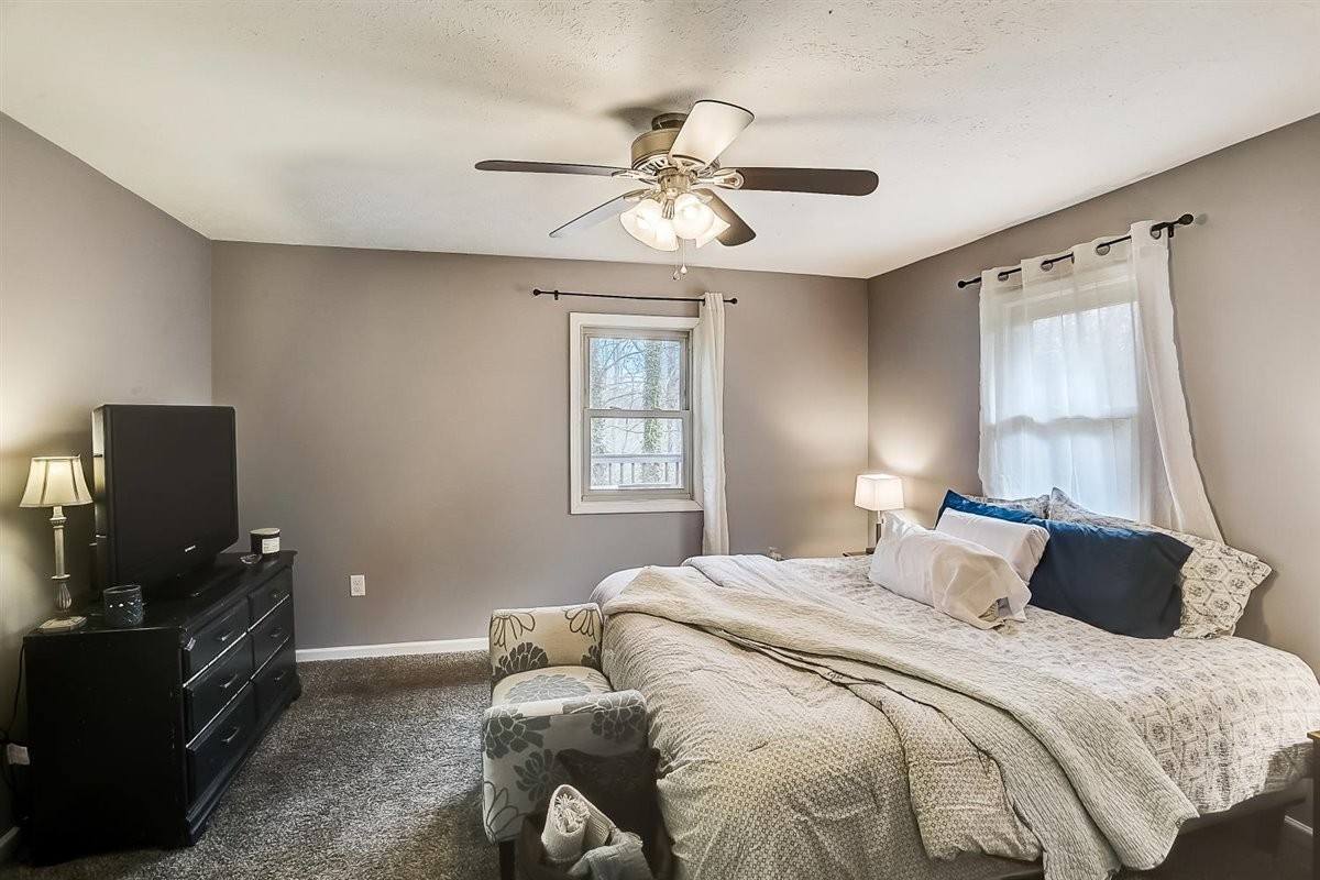 2087 River Road Clarksville, TN 37040 - Photo 15 of 33 a bedroom with a bed and a flat tv screen on the dresser