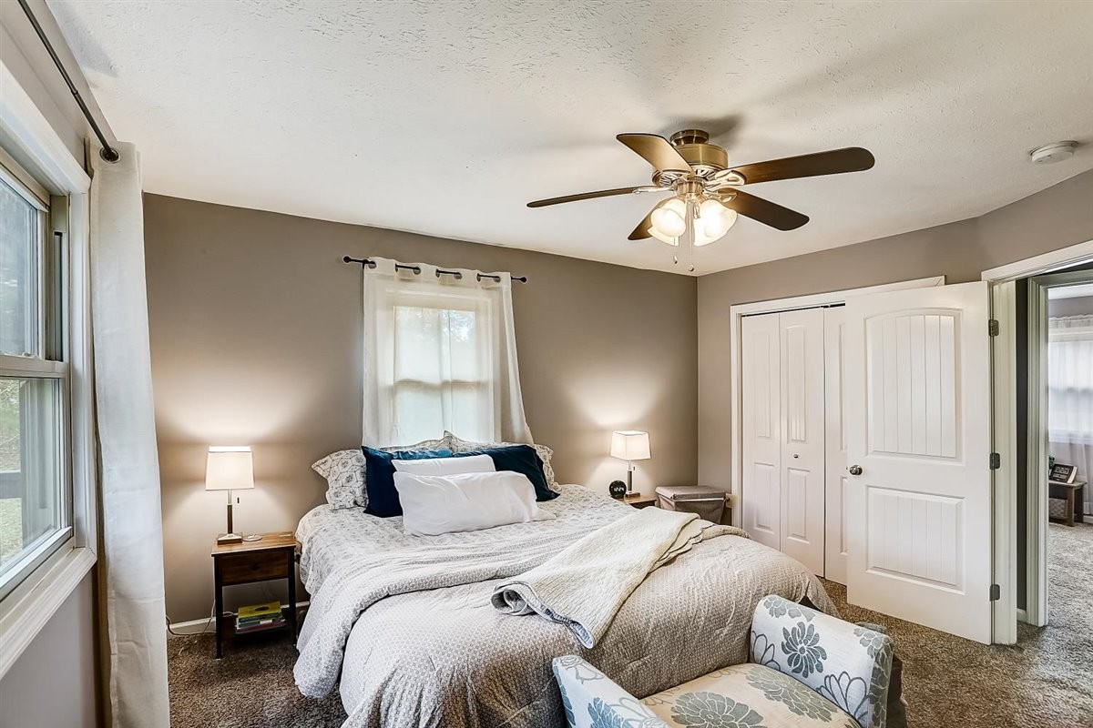 2087 River Road Clarksville, TN 37040 - Photo 16 of 33 a bedroom with a bed and a chandelier