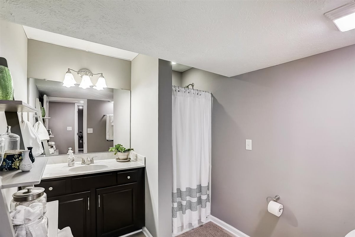 2087 River Road Clarksville, TN 37040 - Photo 24 of 33 a bathroom with a double vanity sink and a mirror
