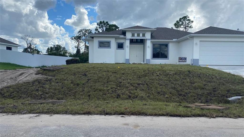 a front view of a house with a yard