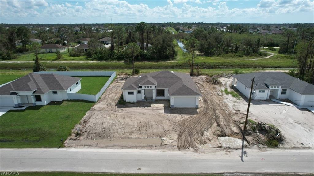 3911 Ordnance Road Lehigh Acres, FL 33971 - Photo 2 of 8 an aerial view of a house with a yard