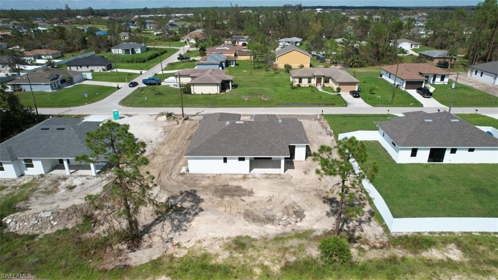 3911 Ordnance Road Lehigh Acres, FL 33971 - Photo 5 of 8 an aerial view of residential houses with outdoor space and parking