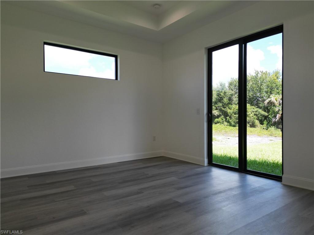 3911 Ordnance Road Lehigh Acres, FL 33971 - Photo 7 of 8 a view of empty room with wooden floor and fan