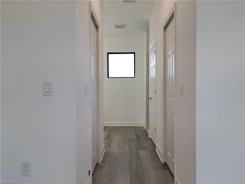 3911 Ordnance Road Lehigh Acres, FL 33971 - Photo 8 of 8 a view of a hallway with wooden floor