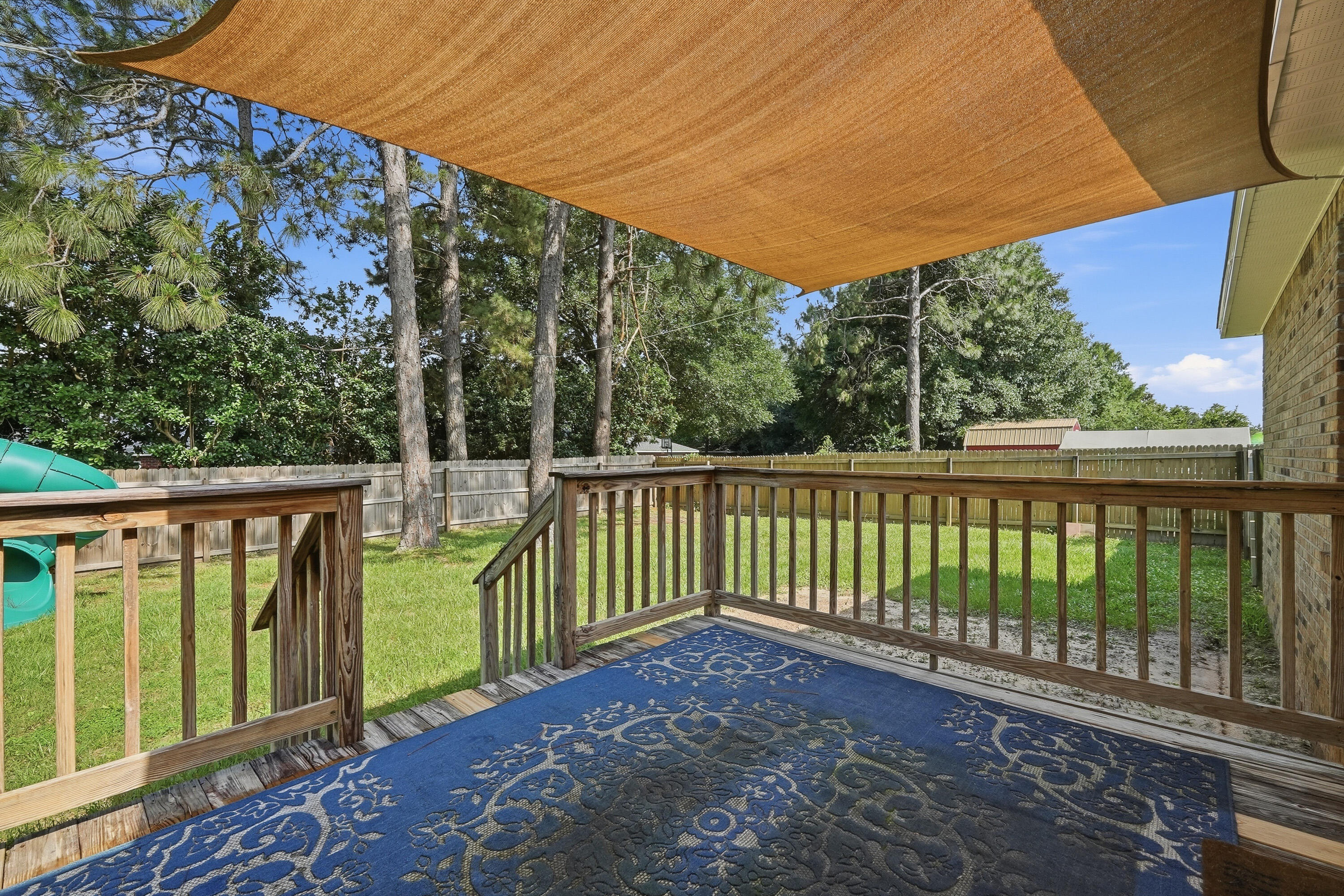 3033 Cabela Lane Crestview, FL 32539 - Photo 31 of 32 a balcony with wooden floor and outdoor space