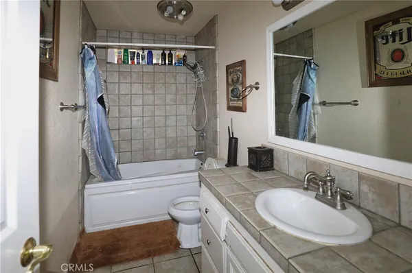 a bathroom with a granite countertop toilet sink and shower