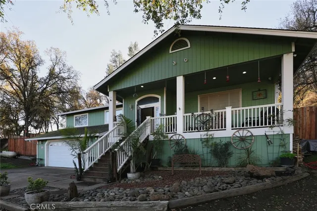 a front view of a house with plants