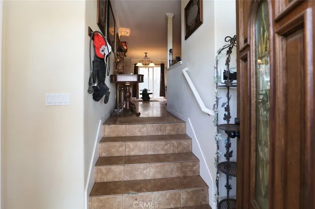 a view of staircase with lots of frames on wall and windows