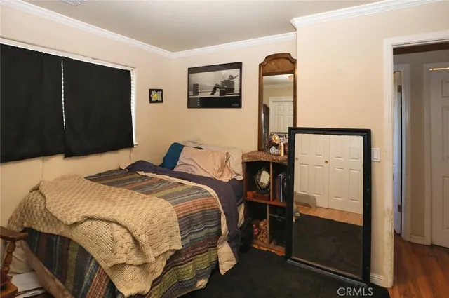 a bedroom with a bed and a mirror