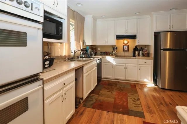 a kitchen with a sink stove and refrigerator