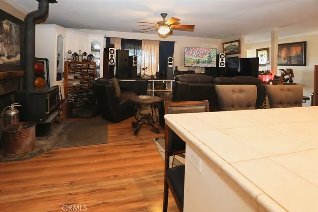 a kitchen with stainless steel appliances kitchen island granite countertop a table chairs and a refrigerator