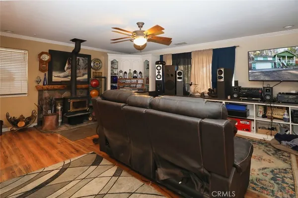 a living room with furniture a air conditioner vent and a window