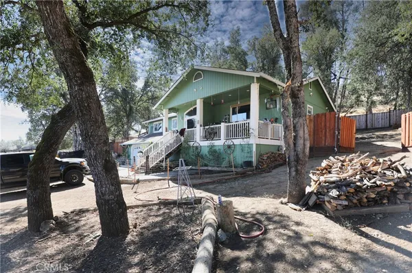 a patio with table and chairs and potted plants