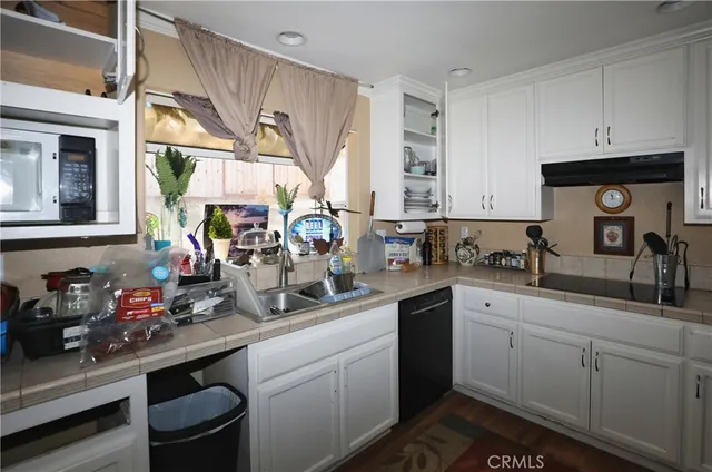 a kitchen with sink cabinets and window