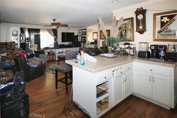 a kitchen with stainless steel appliances white cabinets and wooden floor