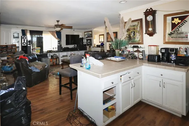 a kitchen with stainless steel appliances white cabinets and wooden floor