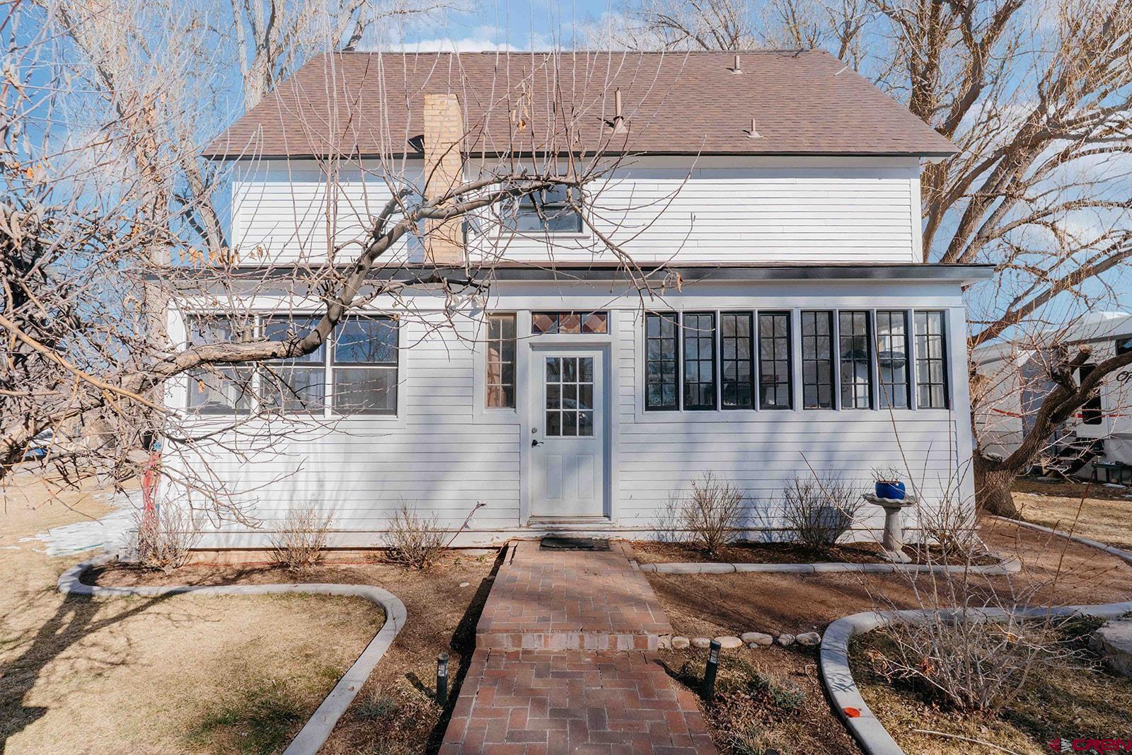 a front view of a house with parking space
