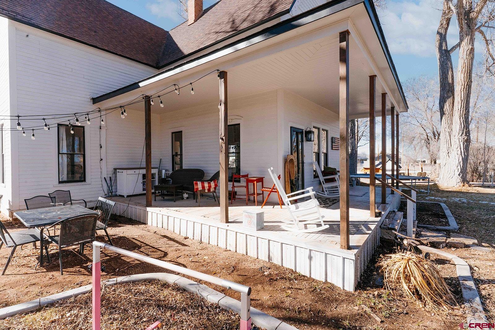62966 Ohlm Road Montrose, CO 81403 - Photo 35 of 43 a view of a house with wooden deck and furniture