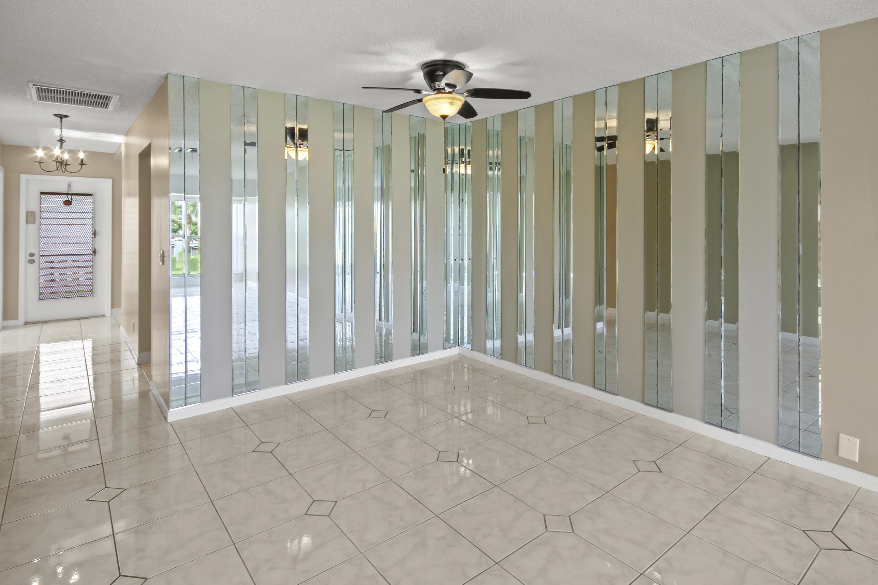 1421 Northwest 20th Avenue, Unit 204 Delray Beach, FL 33445 - Photo 13 of 22 a view of a bathroom with a shower a sink and a mirror