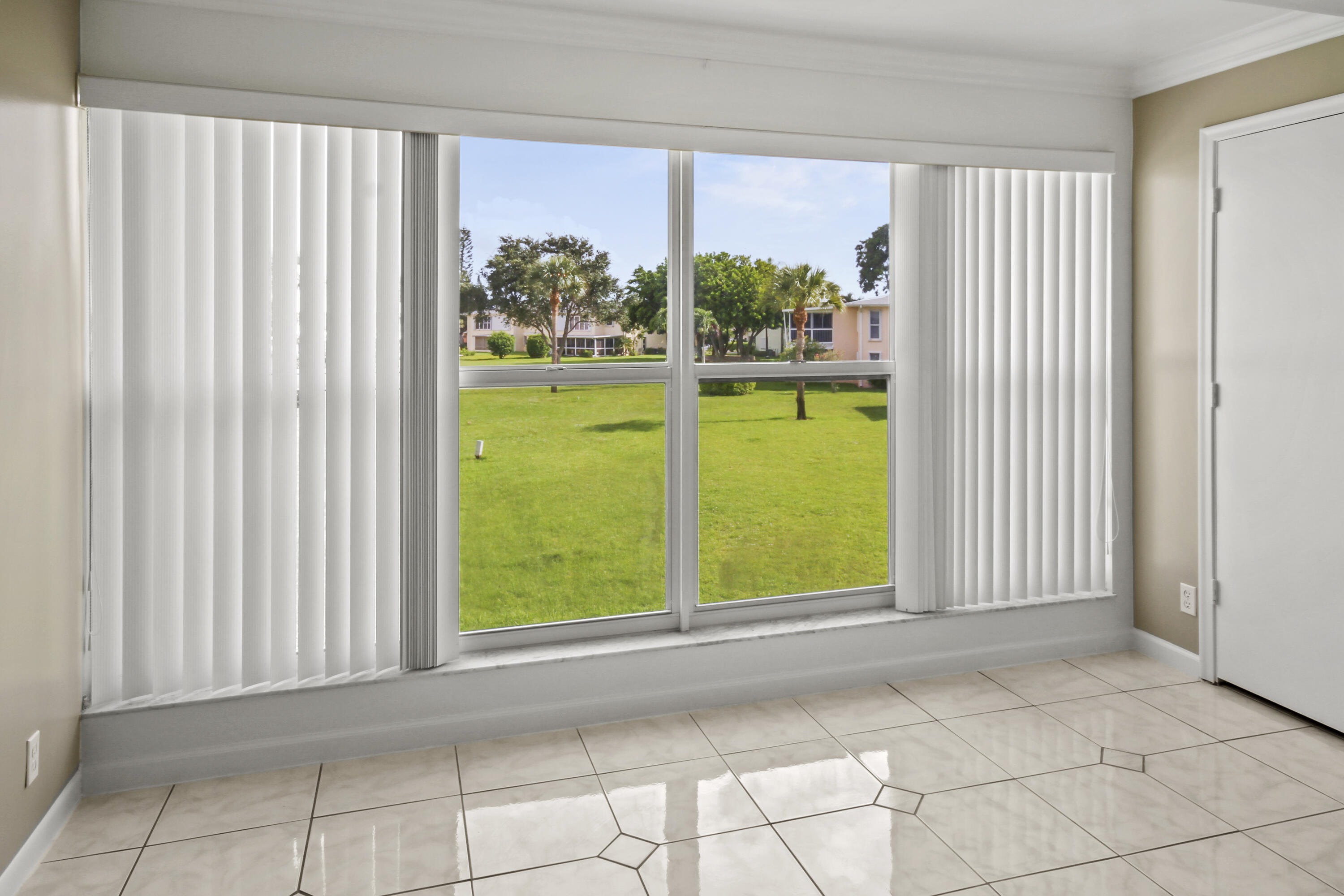 1421 Northwest 20th Avenue, Unit 204 Delray Beach, FL 33445 - Photo 21 of 22 a view of an empty room with a window and a kitchen