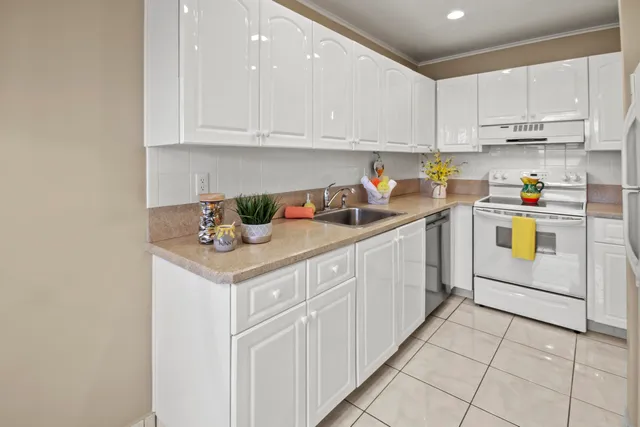 a kitchen with stainless steel appliances granite countertop a sink and cabinets