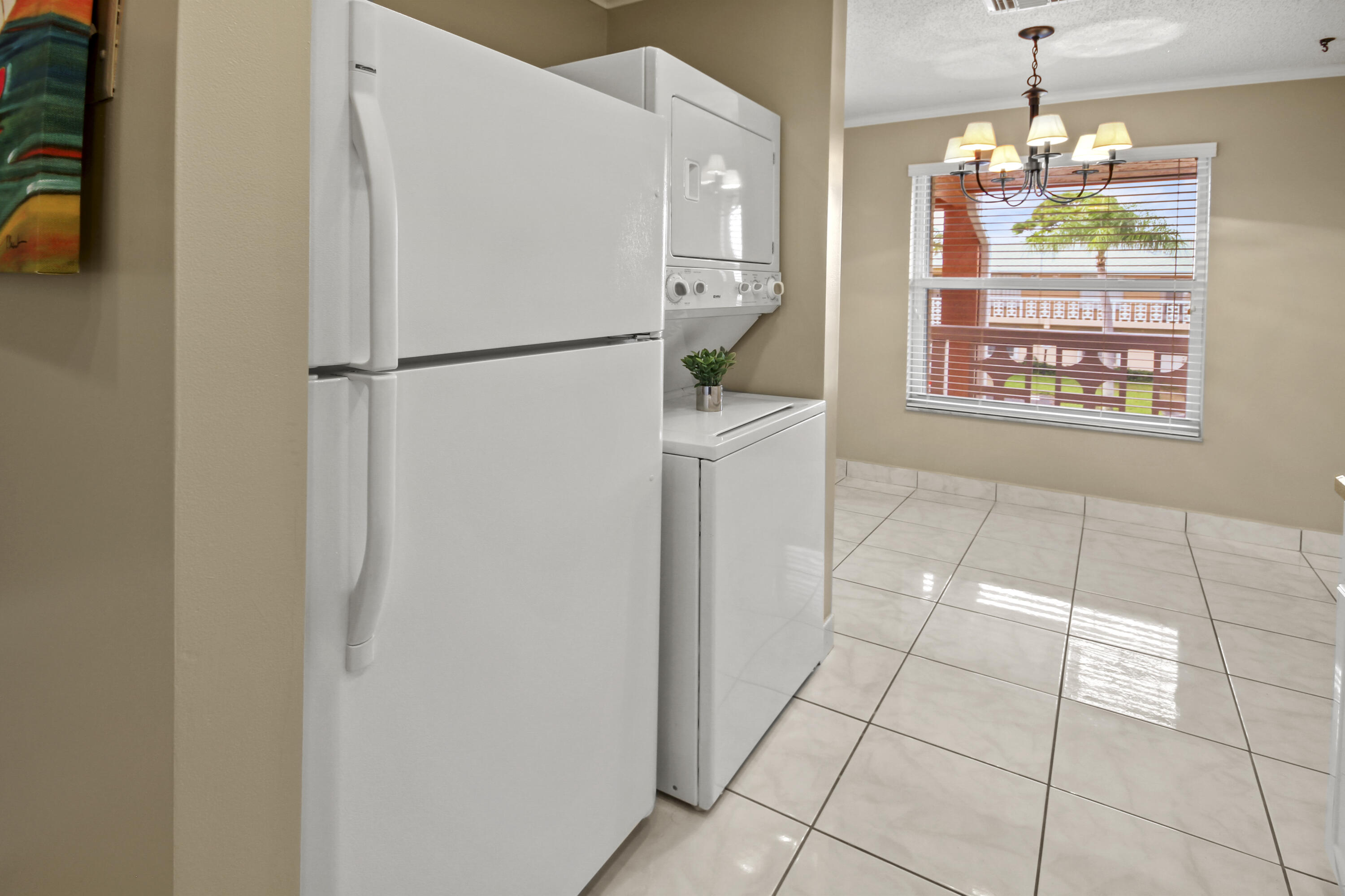 1421 Northwest 20th Avenue, Unit 204 Delray Beach, FL 33445 - Photo 5 of 22 a kitchen with stainless steel appliances a refrigerator and a stove top oven