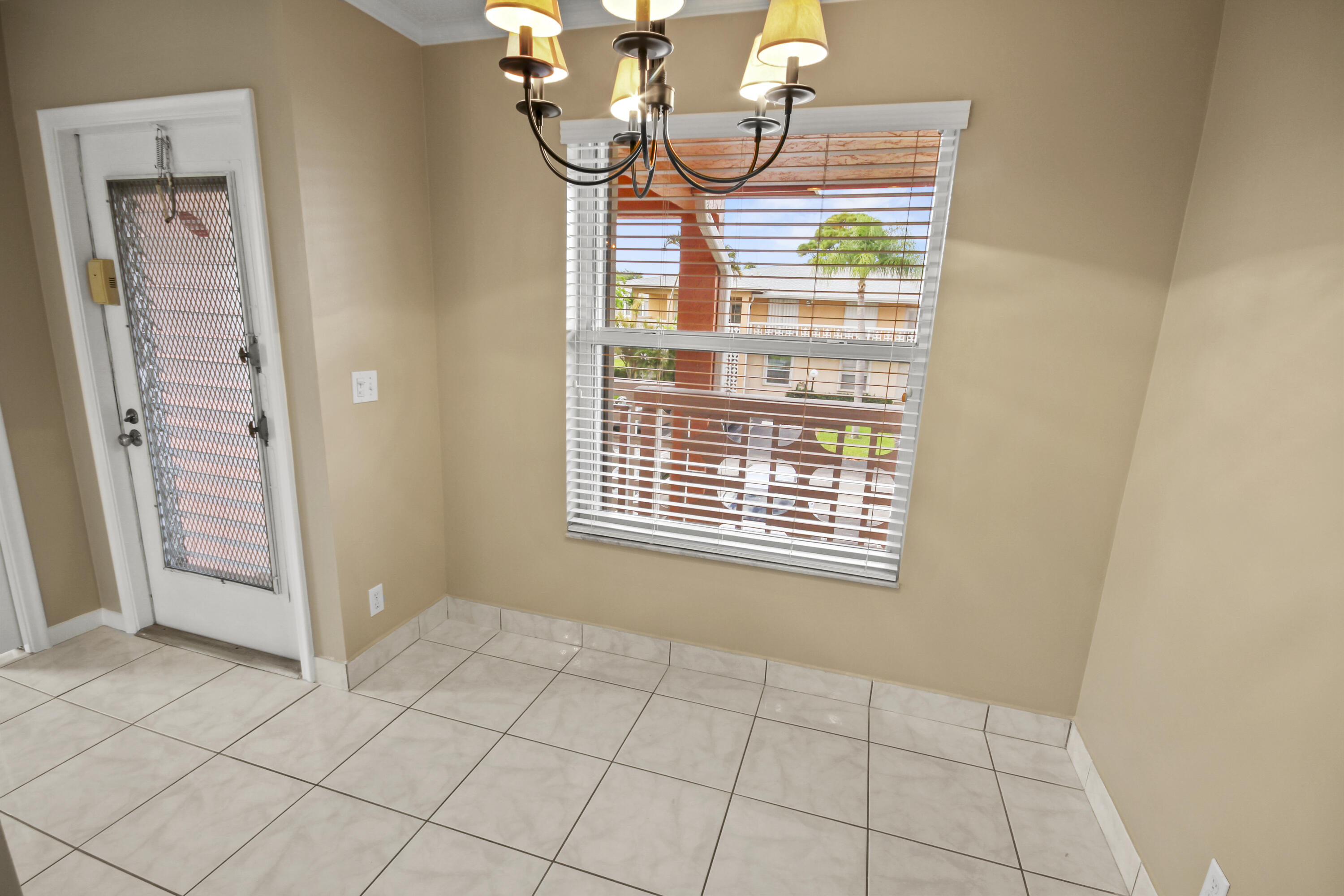 1421 Northwest 20th Avenue, Unit 204 Delray Beach, FL 33445 - Photo 6 of 22 a view of a livingroom with an entryway and a window