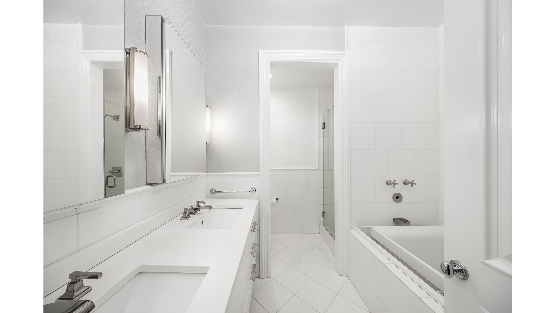 18 East 62nd Street Manhattan, NY 10065 - Photo 15 of 19 a bathroom with a tub sink and mirror