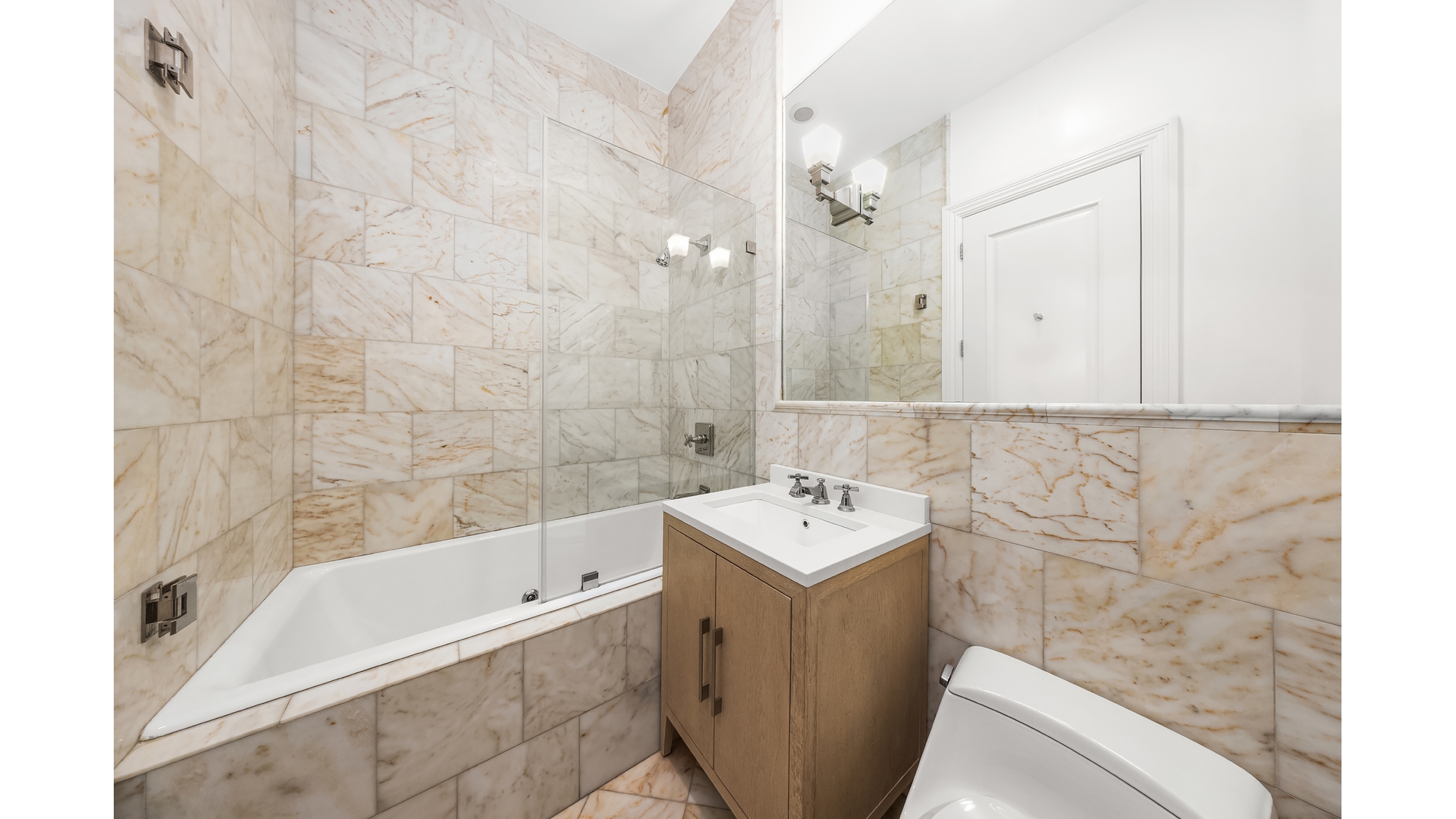 18 East 62nd Street Manhattan, NY 10065 - Photo 17 of 19 a bathroom with a sink a toilet and shower