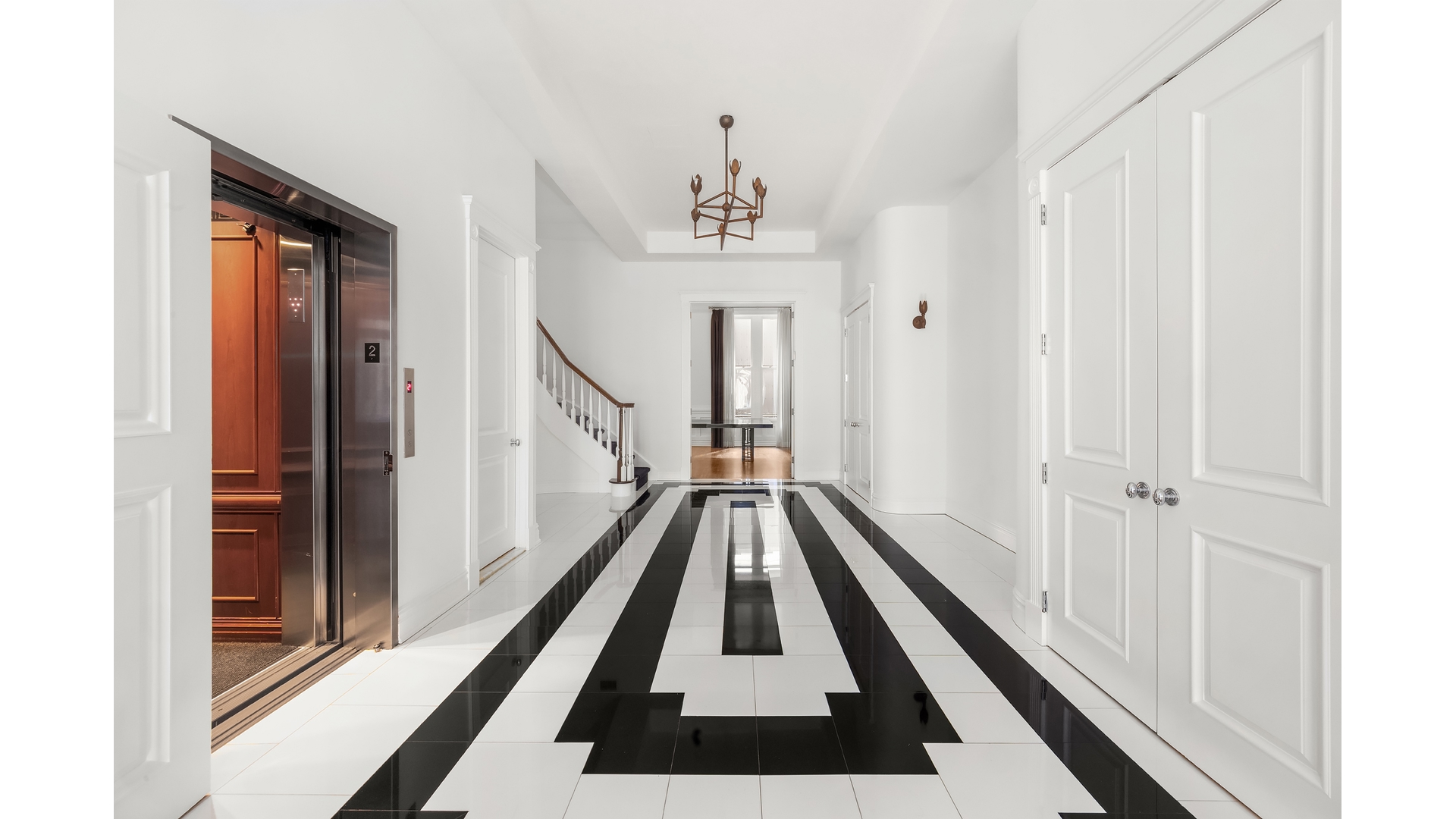 18 East 62nd Street Manhattan, NY 10065 - Photo 7 of 19 a view of a hallway with wooden floor and staircase