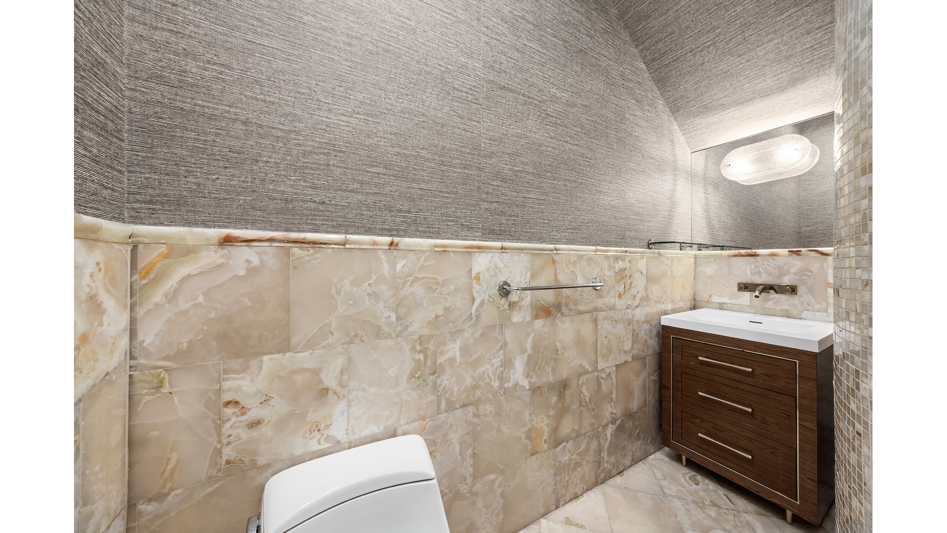 18 East 62nd Street Manhattan, NY 10065 - Photo 10 of 19 a bathroom with a sink and mirror