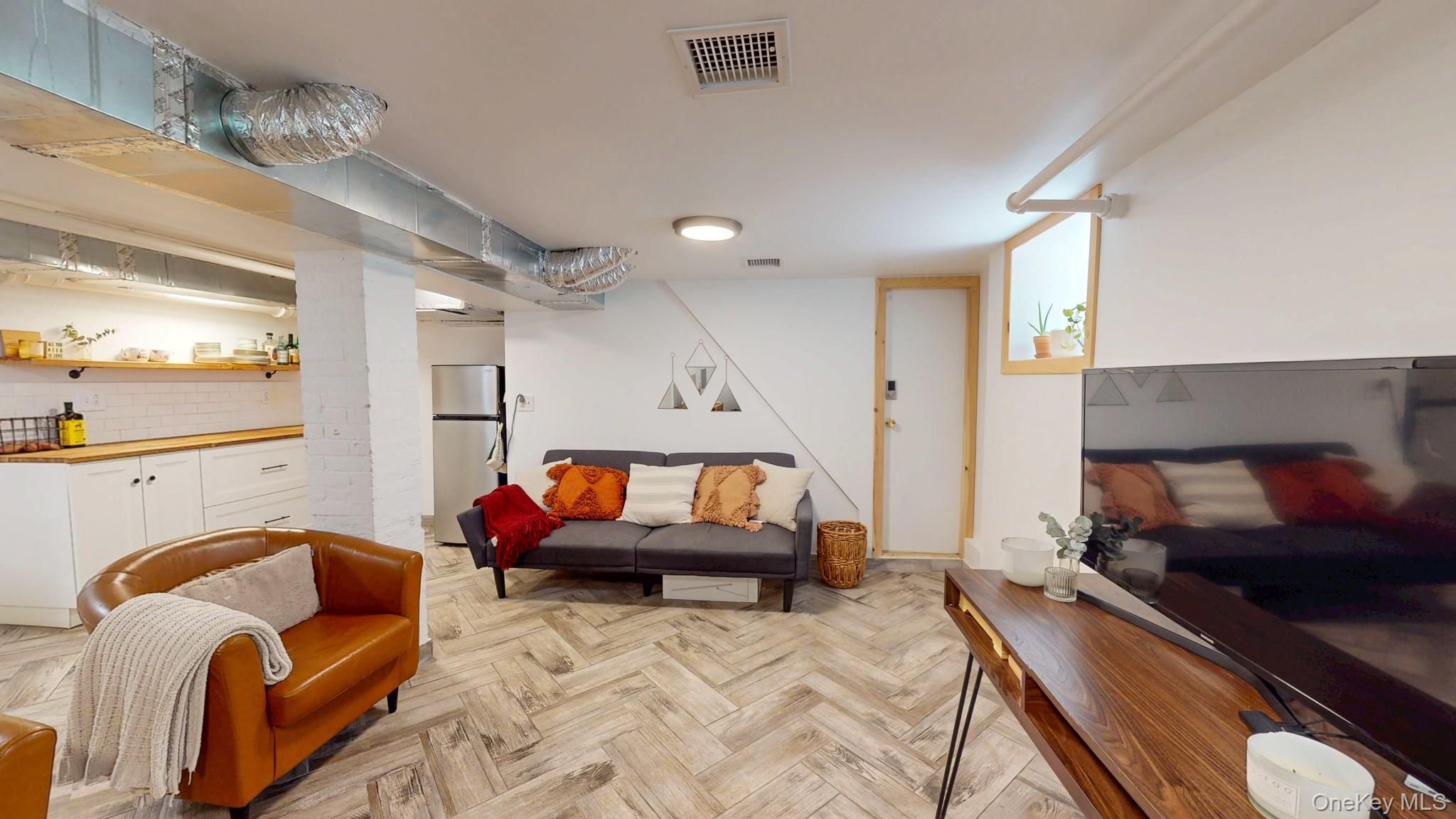 12 Perry Creek Road Washingtonville, NY 10992 - Photo 37 of 50 a living room with furniture and a flat screen tv