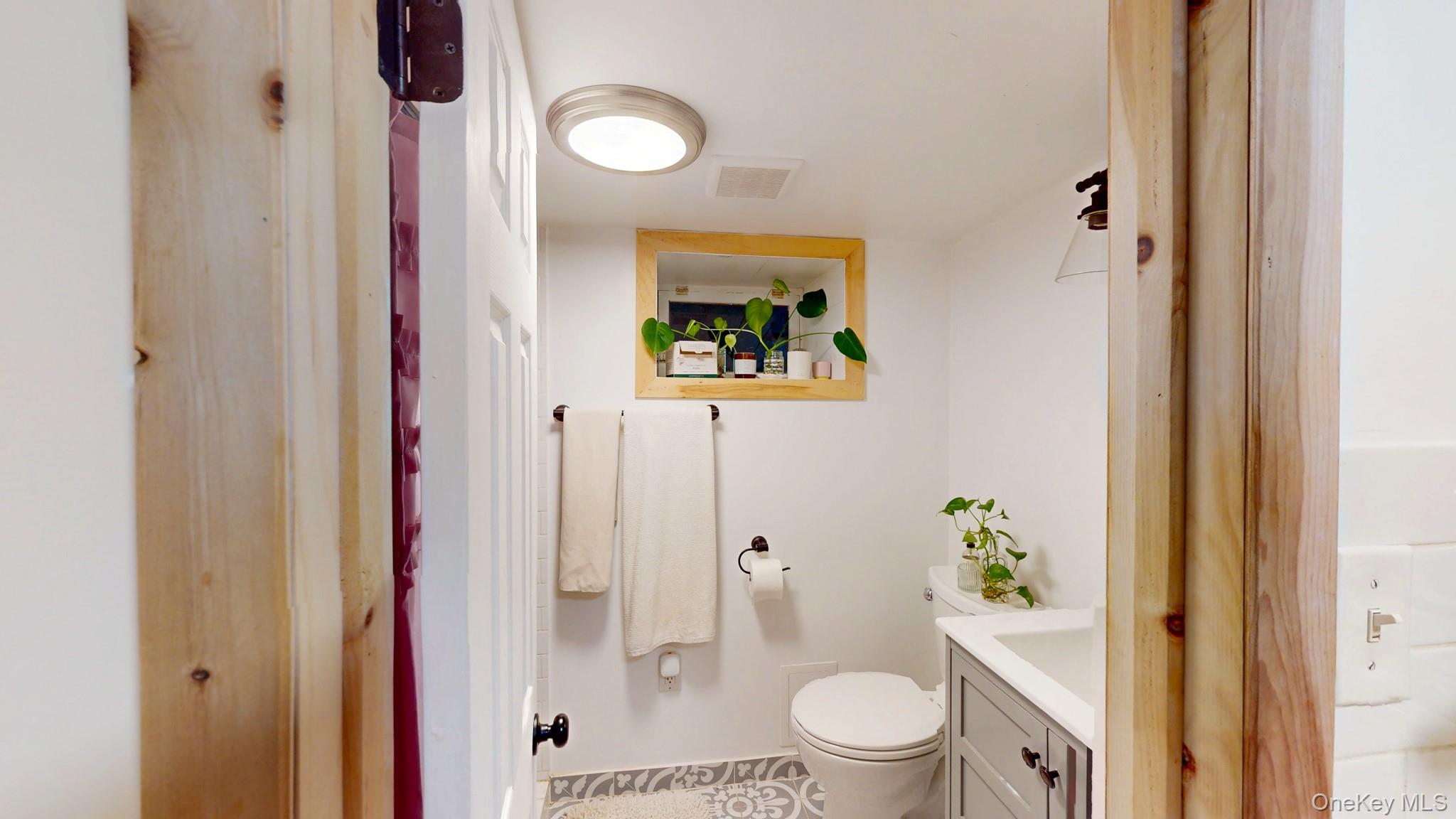 12 Perry Creek Road Washingtonville, NY 10992 - Photo 38 of 50 a bathroom with a toilet a sink and shower curtain