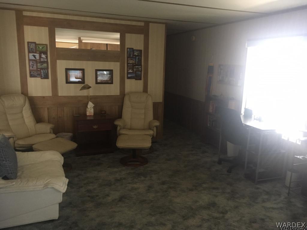 1652 Gran Circulo Fort Mohave, AZ 86426 - Photo 12 of 15 a living room with couches and a dining table with exposed radiator