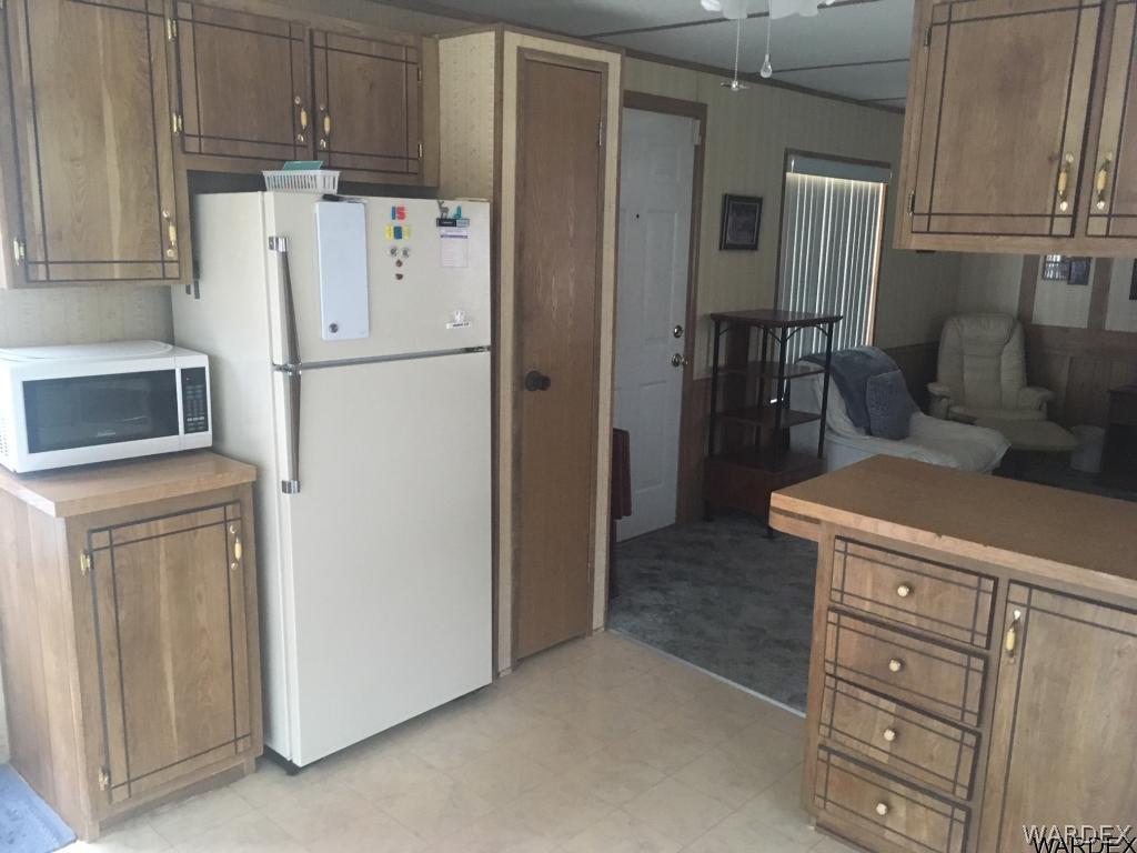 1652 Gran Circulo Fort Mohave, AZ 86426 - Photo 14 of 15 a white refrigerator freezer and a stove sitting inside of a kitchen